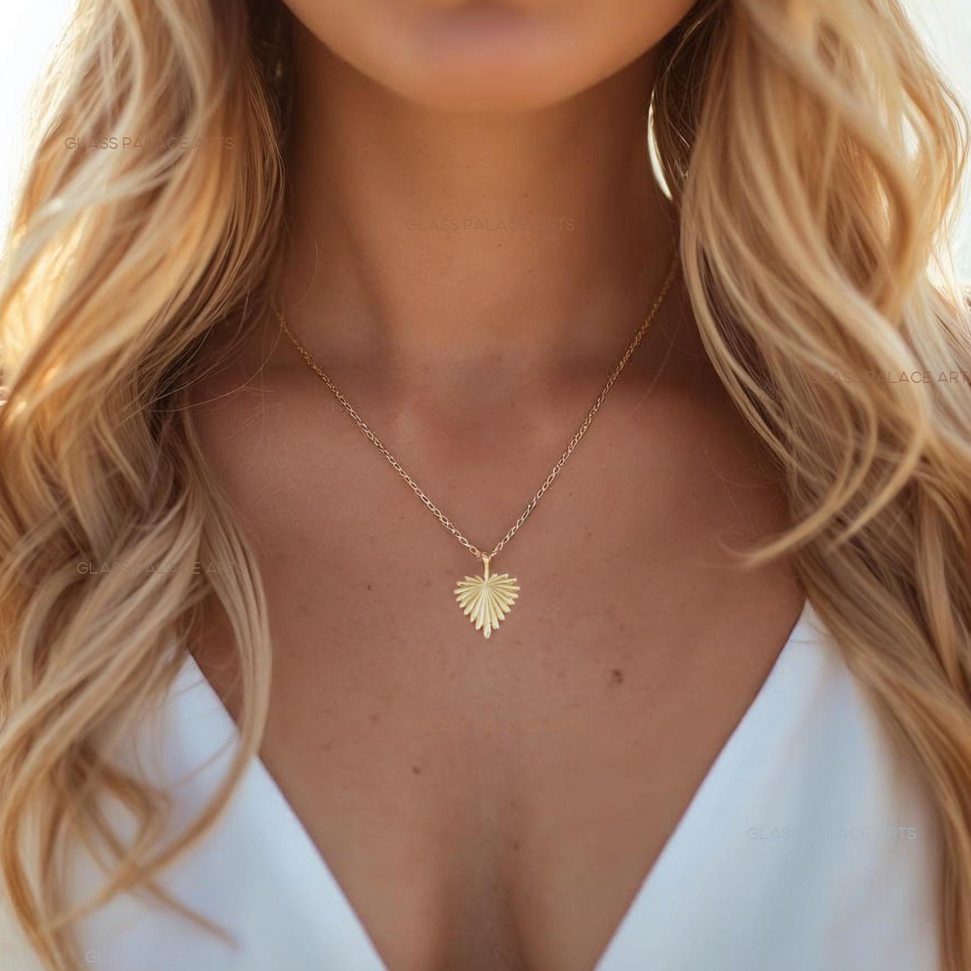 Woman wearing a gold necklace with a heart-shaped pendant, blurred background