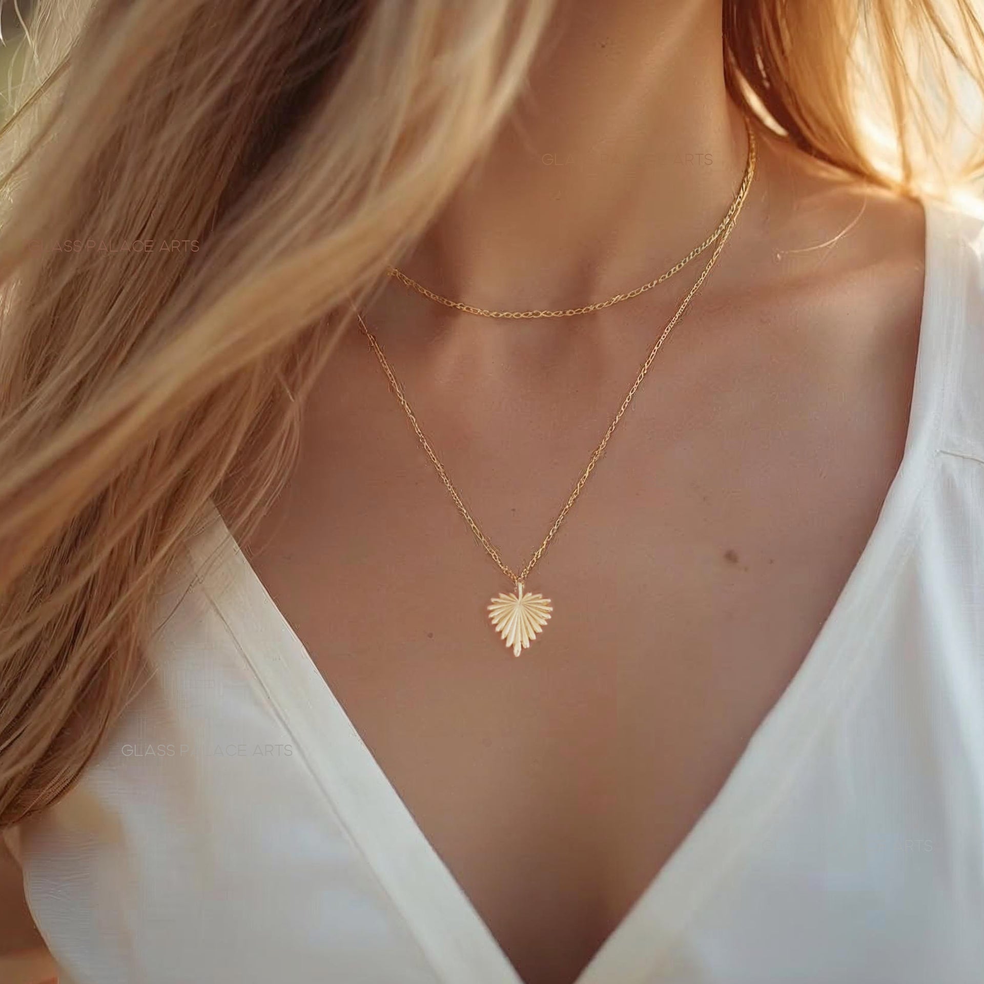 Woman wearing a gold heart-shaped necklace with a blurred background