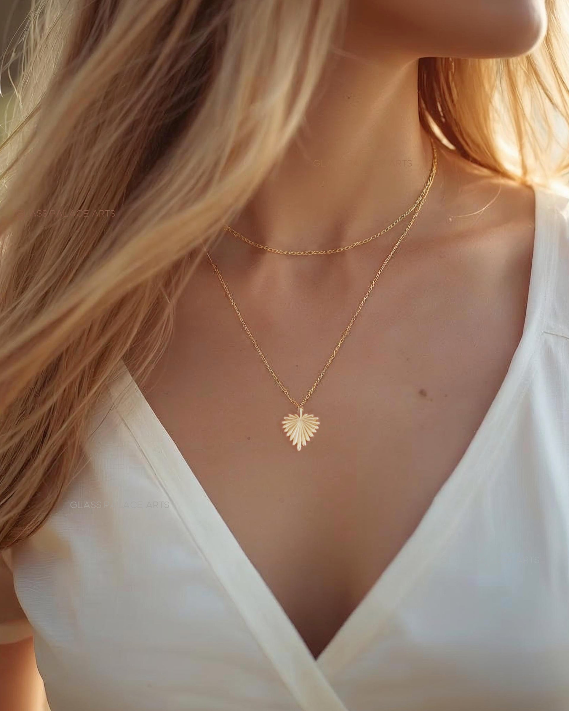 Woman wearing a gold heart-shaped necklace with a blurred background