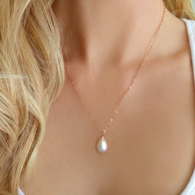 woman wearing rose gold white pearl teardrop necklace