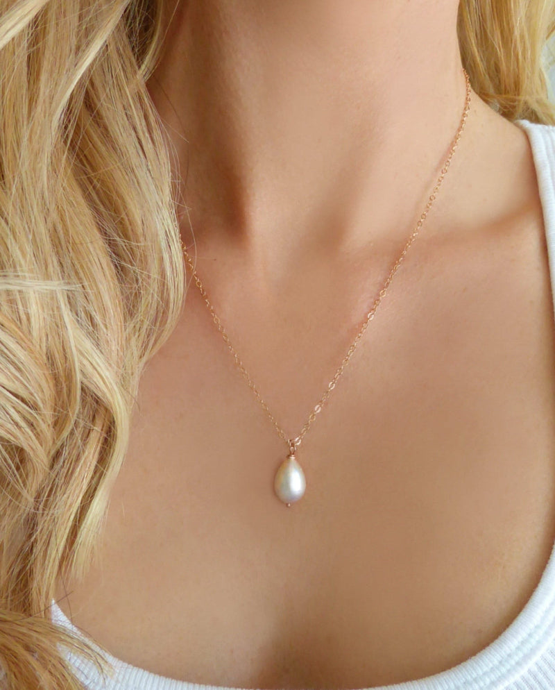 woman wearing rose gold white pearl teardrop necklace