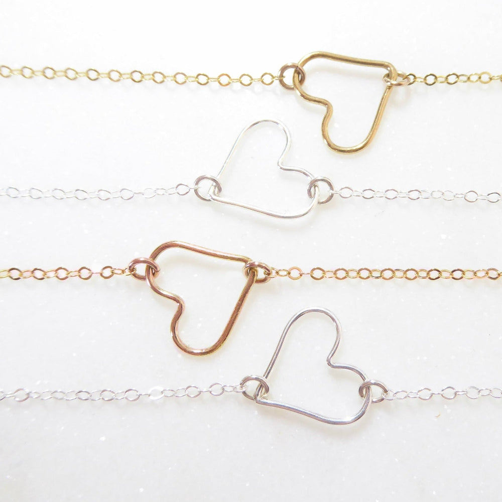 open heart necklaces on white background