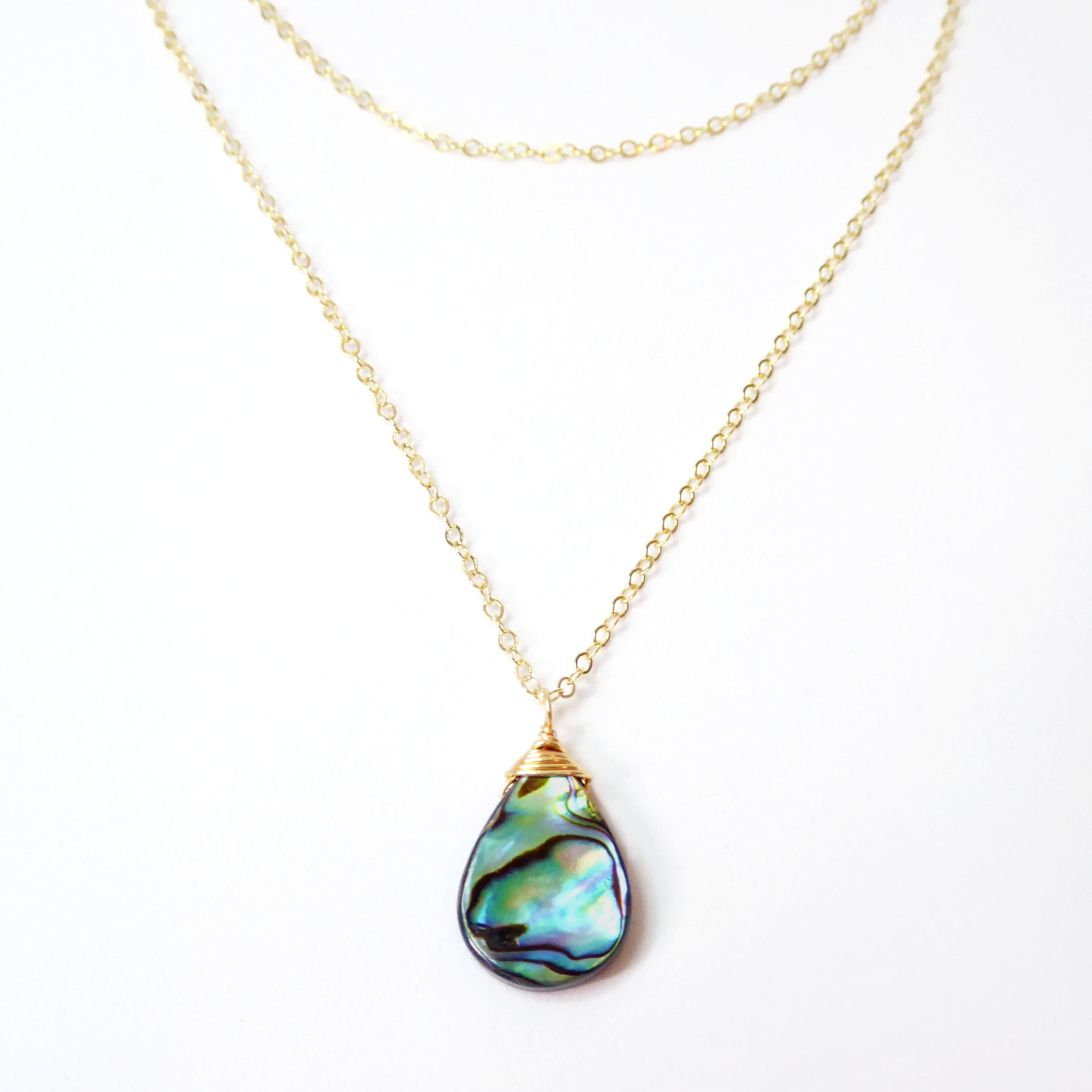 abalone layered multi strand pendant necklace on woman