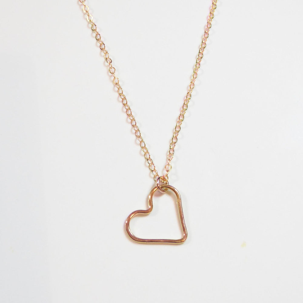 A delicate rose gold chain necklace featuring an open heart-shaped pendant, displayed against a clean white background with a subtle watermark at the top.
