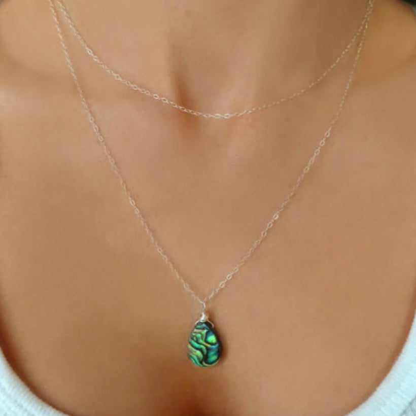 abalone layered multi strand pendant necklace on woman