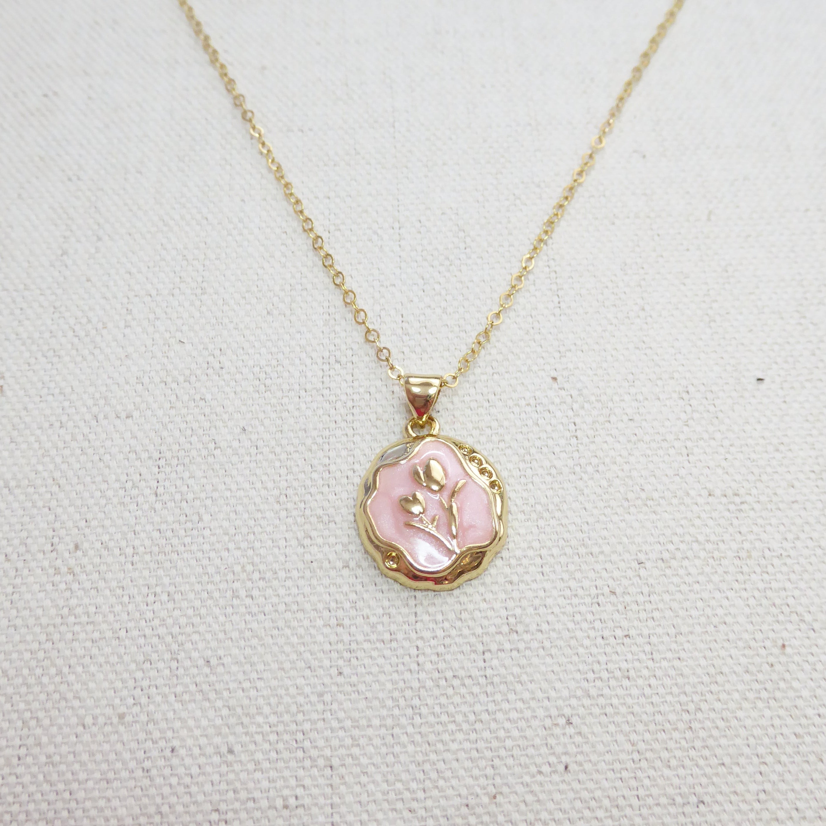 Necklace with a pink pendant on a light gray background
