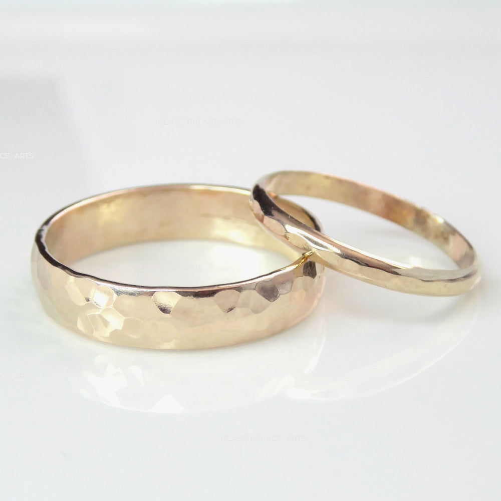 14k gold hammered wedding band set on white background