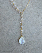 moonstone lariat necklace on grey background