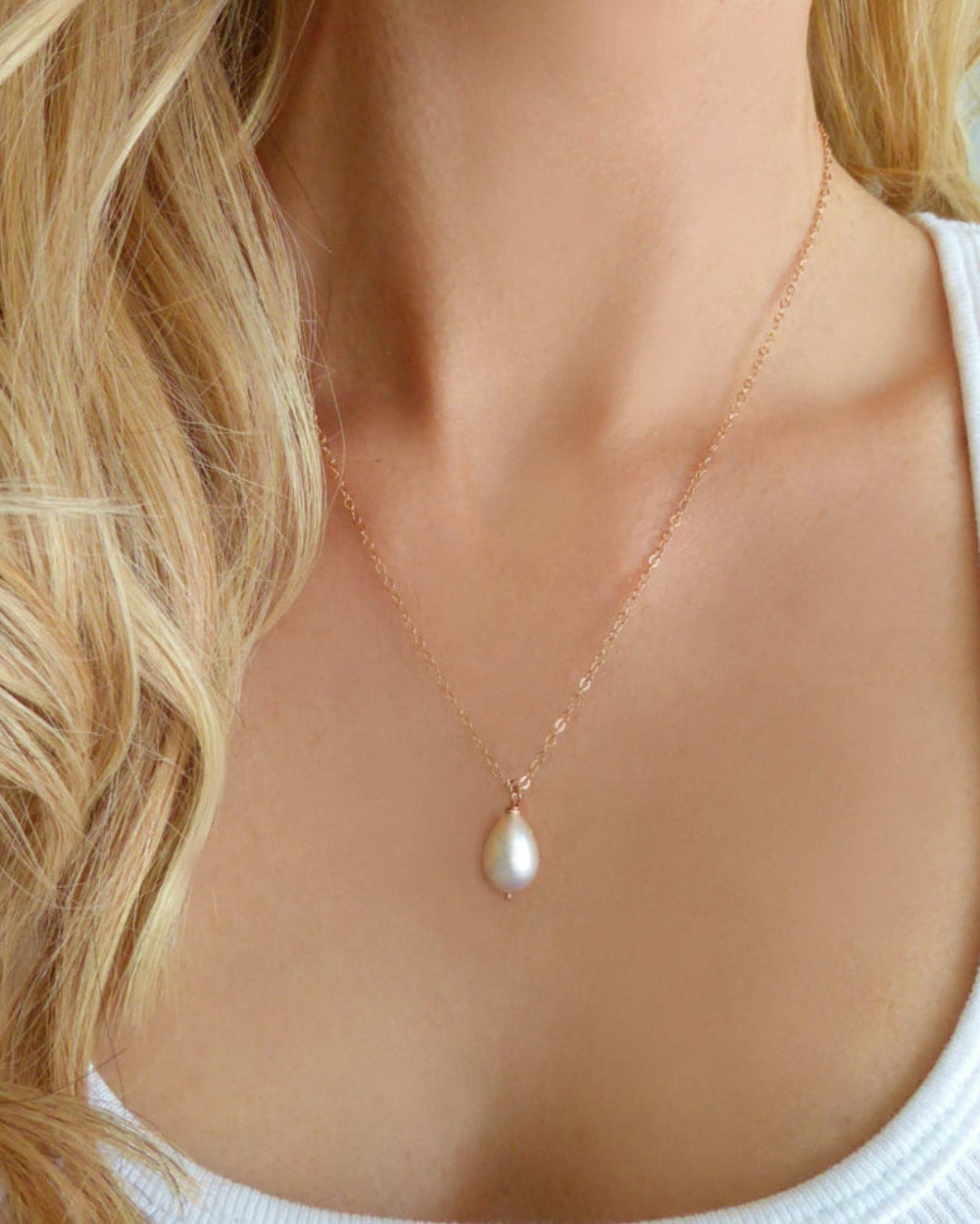 woman wearing rose gold white pearl teardrop necklace