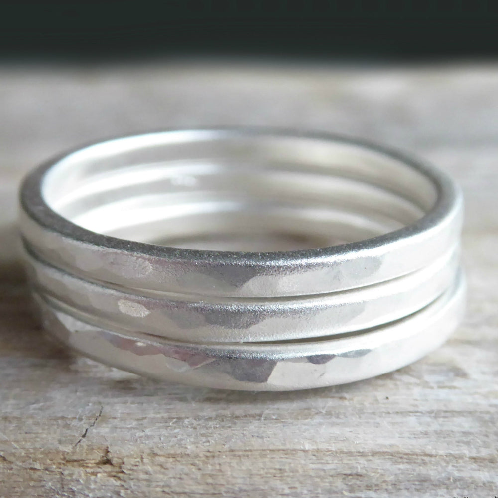 sterling silver hammered rings on grey background