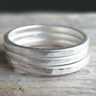 sterling silver hammered rings on grey background