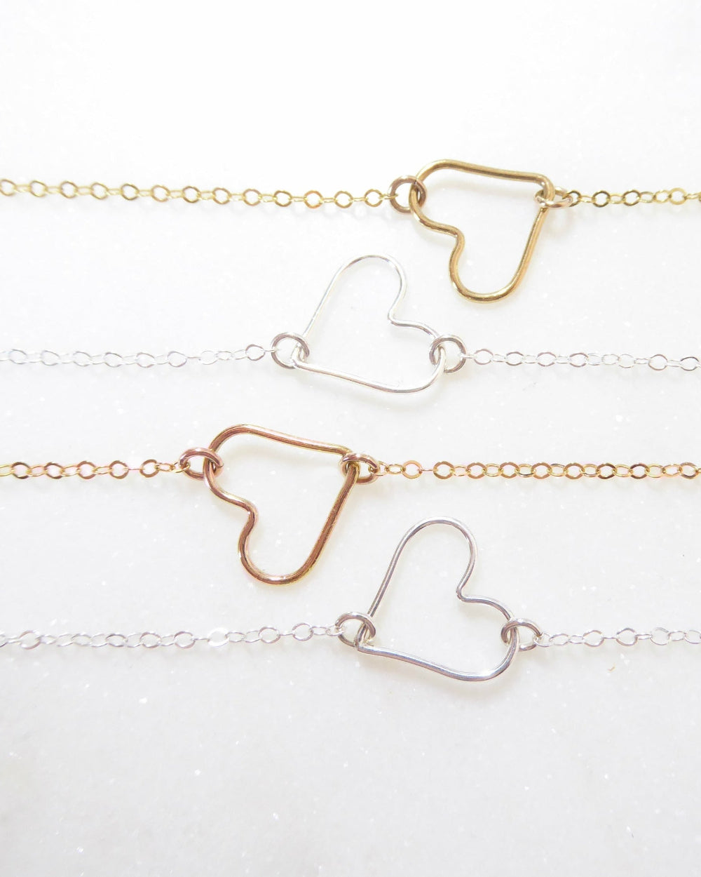 open heart necklaces on white background