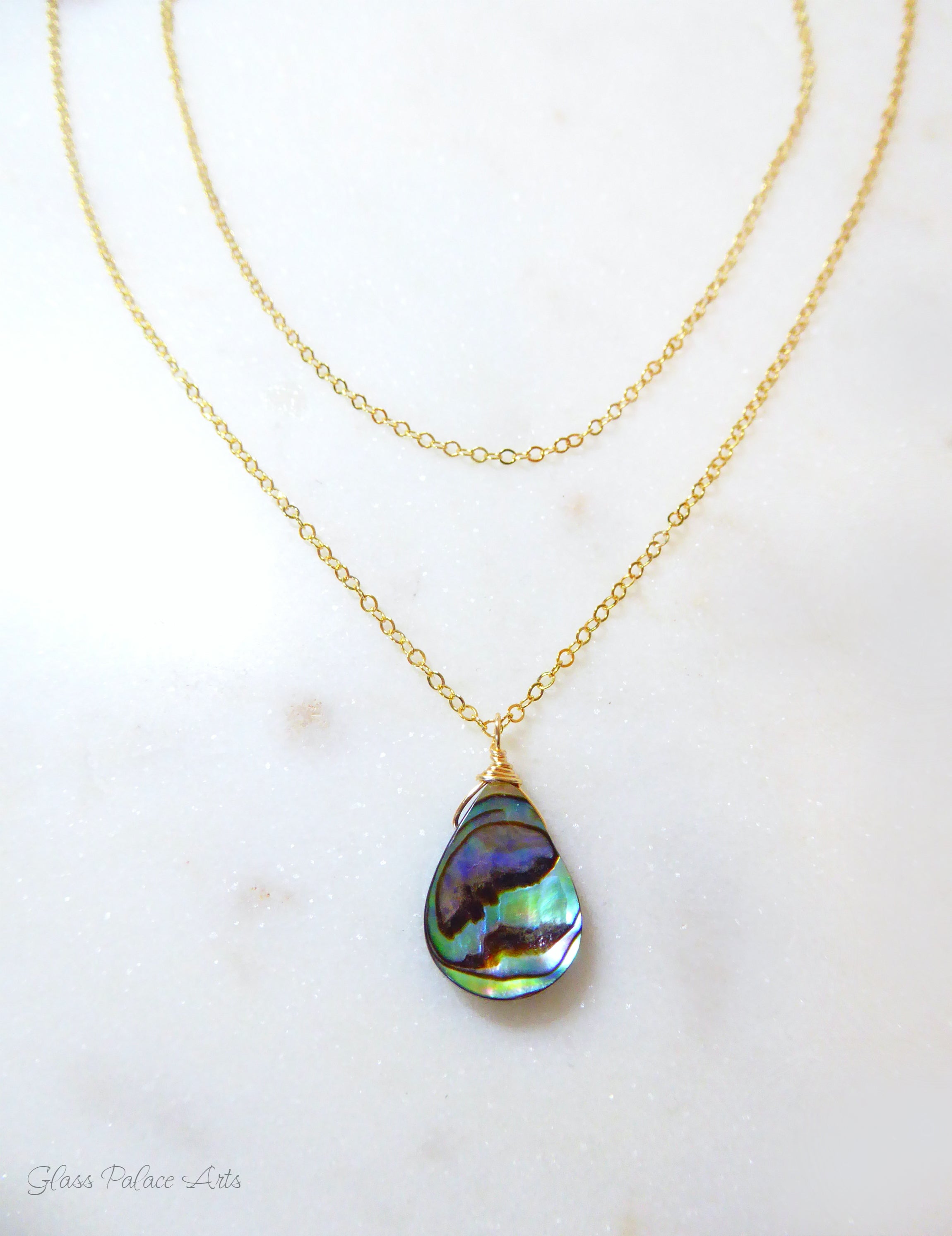 abalone layered multi strand pendant necklace on woman