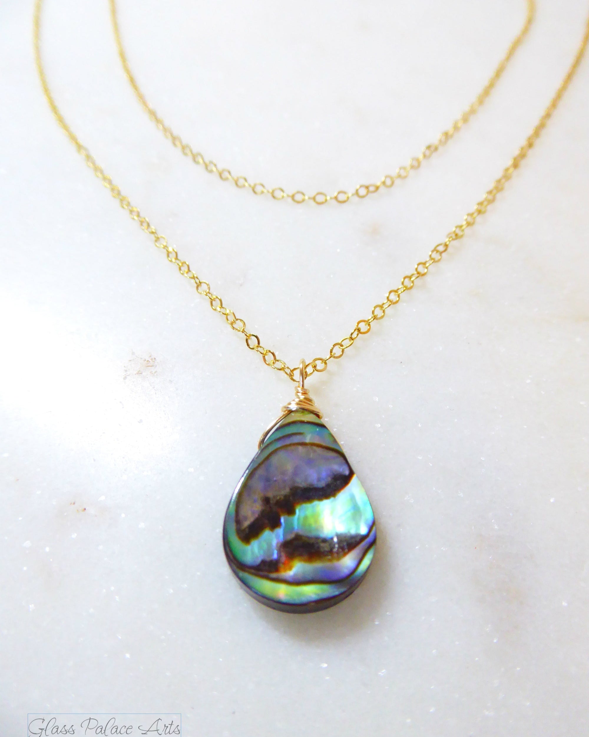 abalone layered multi strand pendant necklace on woman
