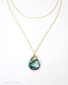 abalone layered multi strand pendant necklace on woman
