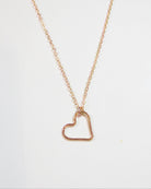 A delicate rose gold chain necklace featuring an open heart-shaped pendant, displayed against a clean white background with a subtle watermark at the top.