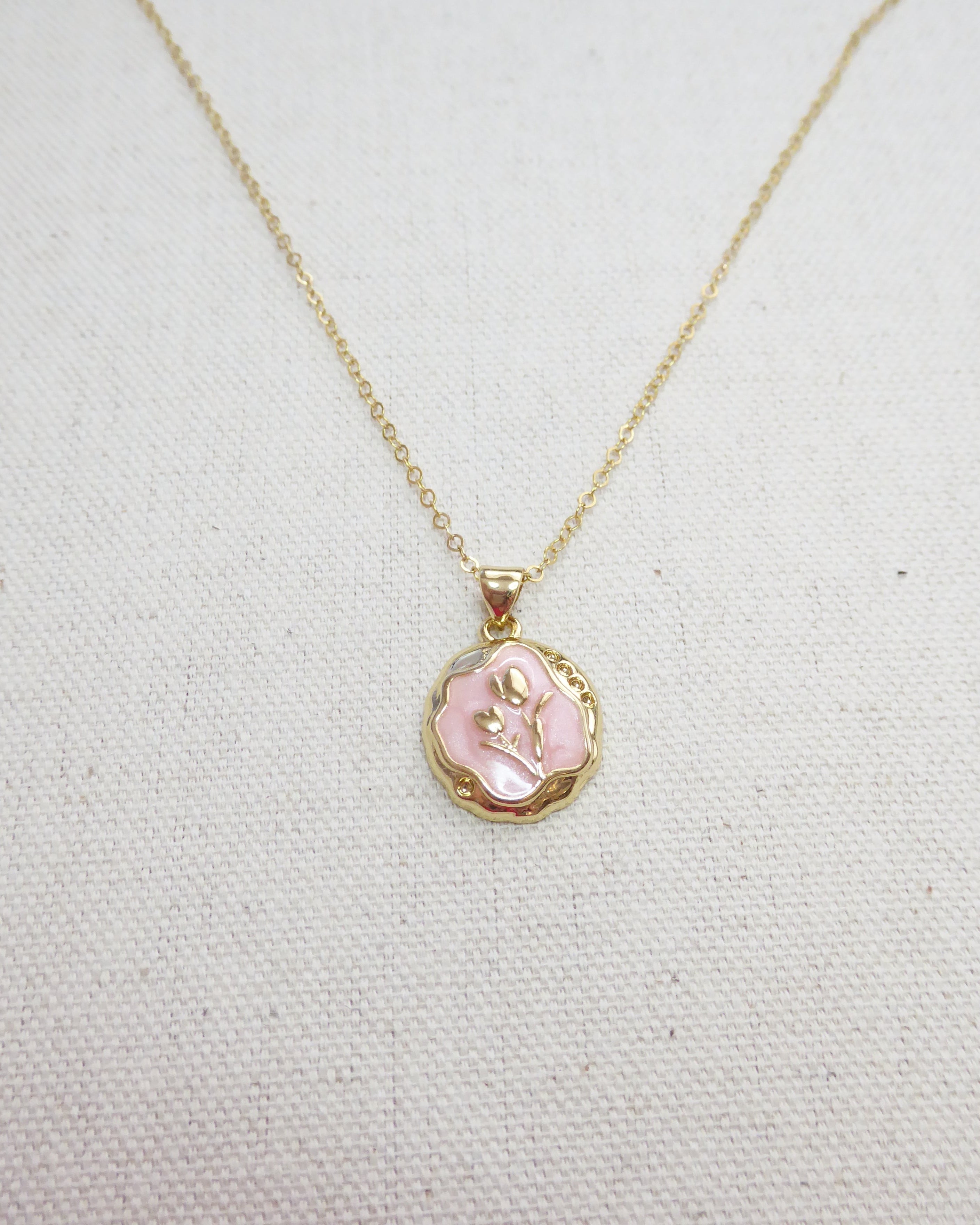 Necklace with a pink pendant on a light gray background